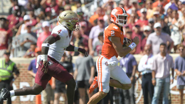 Clemson Tigers quarterback Cade Klubnik (2) runs against Florida State Seminoles linebacker Karen DeLoach (4) during the second quarter at Memorial Stadium.